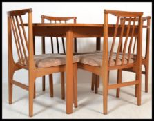 A 20th century teak wood Danish influence dining table and chairs suite by G-Plan. The extending