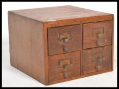 A vintage retro 20th century industrial office four section filing unit having brass name holder