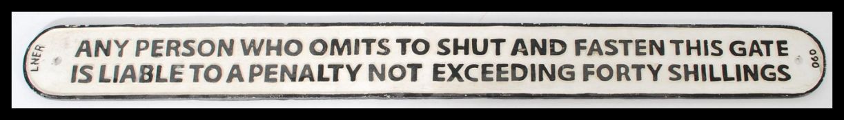 A reproduction 20th century LNER cast iron railway station sign regards gate closing. 3ft in length.