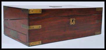 A 19th century Georgian walnut and brass bound writing slope of rectangular form  Opening to