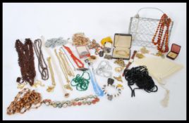 A large collection of vintage costume jewellery to include glass bead necklaces, Miracle dress