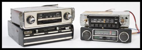 A group of four vintage car radio receivers to include an 8 Track player, Philips etc please refer