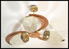 A collection of vintage lighting and fixtures to include a retro teak boomerang ceiling light, glass