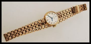 Lady's Lanco 9ct gold cased cocktail watch having Arabic numerals on a 9ct gold hallmarked bracelet.