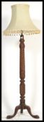 A good, large 19th century mahogany barley twist standard lamp being raised on a splayed legs base