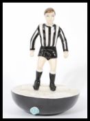 A Royal Doulton Subbuteo ceramic football figurine MCL 12 featuring a player in black and white