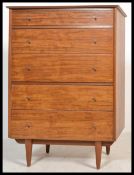 A good mid century Danish influence teak wood pedestal chest of drawers being raised on tapering