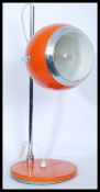 A vintage retro 20th century eye ball spot lamp raised on a circular base with adjustable tubular