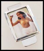 A contemporary novelty sterling silver money clip featuring an enamel panel including a portrait