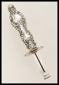 A Victorian hallmarked silver propelling intaglio seal holder having an ornate scrolled handle.