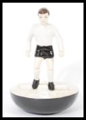 A Royal Doulton Subbuteo ceramic football figurine MCL 12 featuring a player in black and white