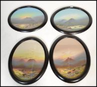 A set of four early 20th century Frank Holmes oil paintings set to ebonised oval frames. Please
