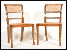 A pair of late 19th century satinwood stencil hand painted dining chairs in the manner of Edwards