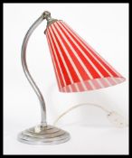 A good mid century table lamp of chrome form having hook arm over terrace base and stunning
