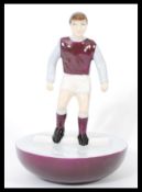 A Royal Doulton Subbuteo ceramic football figurine MCL 12 featuring a player in burgundy and light