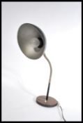 A vintage 20th retro industrial goose neck lamp raised on a circular base with black pendant