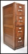 An early 20th century industrial 1920's oak filing cabinet of upright form. The cabinet having