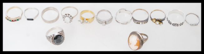 A collection of sterling silver and yellow metal rings consisting of 11 silver rings, one 18k plated