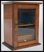 A 19th century Victorian  mahogany smokers cabinet having a glazed open door with inset twin pipe