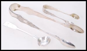A large pair silver hallmarked sugar tongs, marked for Sheffield, together with a smaller