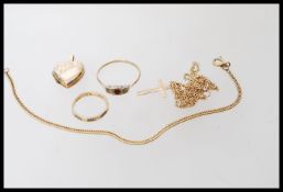 A group of hallmarked and yellow metal stamped 9ct gold jewellery to include two rings, crucifix