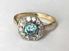 An 18ct gold Art Deco blue zircon and diamond cluster ring set with a central brilliant cut blue