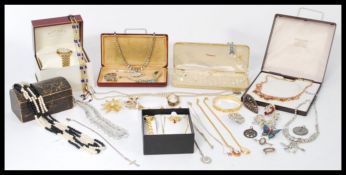 A collection of vintage 20th Century costume jewellery to include brooches, neacklaces, watches,