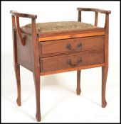 A vintage early 20th century Edwardian piano stool having tow pull out fold front drawers with