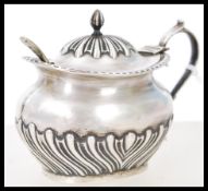 A silver hallmarked condiment pot with lid complete with blue glass liner. The silver hallmarked for