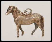 A silver hallmarked miniature model of a horse having necklace bale hoop to top.
