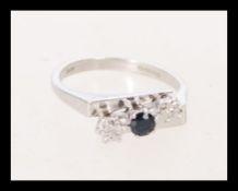 A hallmarked 9ct white gold sapphire and diamond trilogy ring. Hallmarked London. Weight 3.3g.