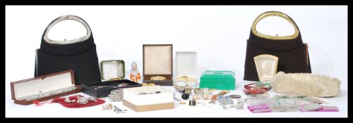 A group of vintage costume jewellery to include handbags, brooches, necklaces, watches, silver items