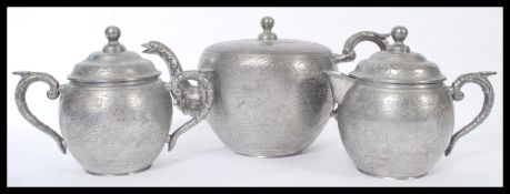 An early 20th century Chinese silver plate three piece tea service of bulbous form with engraved
