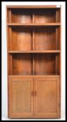 A 1930's Art Deco oak bookcase and cabinet constructed from a ' Racing Eight ' rowing boat. The