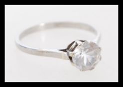 A vintage 9ct white gold ring set with a solitaire white stone in a prong setting. Marked 9ct