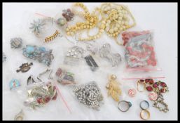 A group of vintage costume jewellery to include bone bead necklaces, brooches, necklaces, West