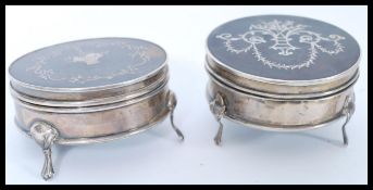 Two silver hallmarked and tortoiseshell boxes of circular form each having inlaid decoration and