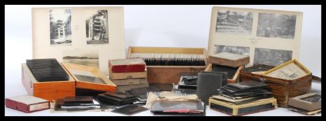 A large collection of 19th century Victorian glass plate slides mostly within wooden slide storage