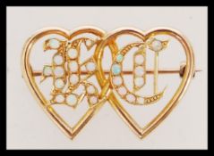 A Victorian 15ct gold and opal set sweetheart Luckenbooth style brooch having entwined hearts with