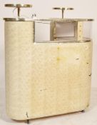 A 1950's mid century retro cocktail bar having raised circular tiers over L-shaped body with white
