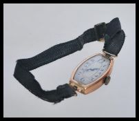 A hallmarked 9ct gold vintage watch having a rectangular case with silvered dial, Arabic numeral