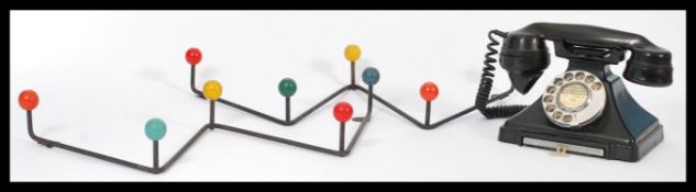 A vintage mid 20th Century bakelite telephone together with a pair of retro atomic wall handing coat