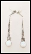 A pair of silver Art Deco style drop earrings set with opals and marcasites. The earrings are