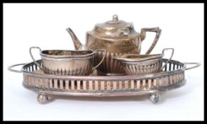 A silver hallmarked miniature dolls house tea service consisting of silver and wooden gallery tray