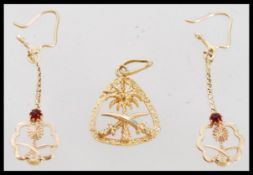 A high carat 22ct unmarked but gold testing set of Saudi Arabian earrings and necklace pendant