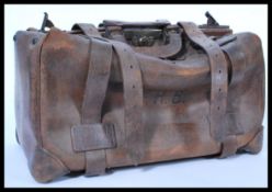 A vintage early 20th century leather Gladstone doctors bag having carry handle to top and lock to