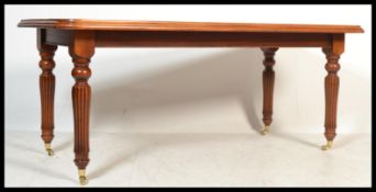 A Regency style mahogany library table in the manner of Gillows of Lancaster raised on turned and
