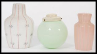 A collection of vintage mid century glass shades to include skittle shaped and globe. Good vibrant
