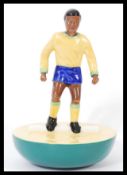 A Royal Doulton Subbuteo ceramic football figurine MCL 12 / 13 featuring a player in Brazilian kit