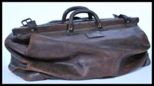 A vintage early 20th century large doctors leather Gladstone bag with carry handle atop. Please